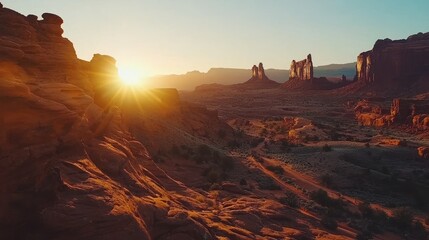 Sunrise over desert landscape with sandstone formations.