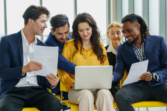 group of diversity business people working with laptop computer and paper work in meeting hall at office .