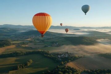 Naklejka premium Hot air balloons drifting majestically above a misty landscape at sunrise in the countryside