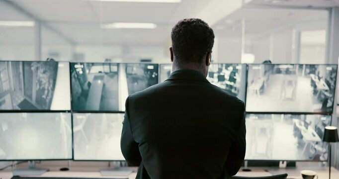 Man, back and security with screen of surveillance in control room for monitoring safety in building. Male person, CCTV operator or mall cop with display on computer for area footage or observation