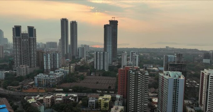 Golden Horizons: Captivating Evening Aerial of Mumbai's Skyline at Sunset, Over Lower Parel, Mahalaxmi, and Currey Road. Silhouette shot of Mumbai's skyline in the evening.