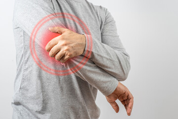 Arthritis symptoms, suffering from pain. The hands of the senior man massage a painful elbow. Inflamed male joint, stiffness of movement. Old age, health. Close up view..