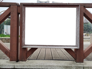 Blank white mockup template of billboard on the wooden fence. Background texture of empty advertising standing sign for restaurants or cafes.space for advertising display in a pubic setting