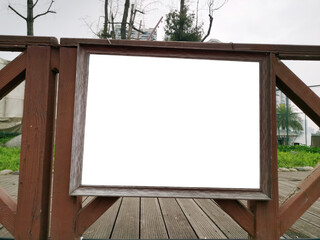 Blank white mockup template of a billboard on wooden fence. Background texture of empty advertising...