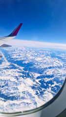 Snowy mountains view from the plane