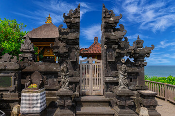 Tanah Lot Temple on the island of Bali known as the island of Gods. Sitting on top of rock island over looking turquoise blue beaches in Bali Indonesia