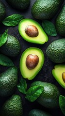 Fresh avocados and green leaves on a dark background creating a vibrant and healthy food composition a top view shot with a studio light