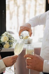 bride and groom holding champagne glasses