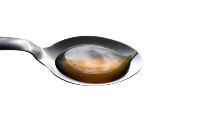 Spoon holding a drop of honey reflecting the sky