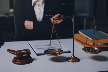 Judge gavel with Justice lawyers having team meeting at law firm background. Concepts of Law and...