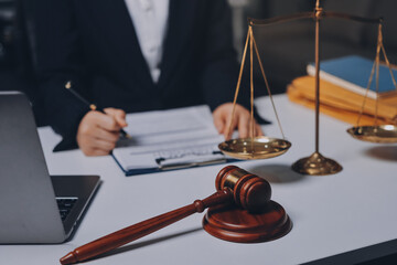 Judge gavel with Justice lawyers having team meeting at law firm background. Concepts of Law and...