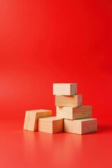 Obraz premium Simple Wooden Blocks Arranged on Vibrant Red Background Forming an Abstract Composition