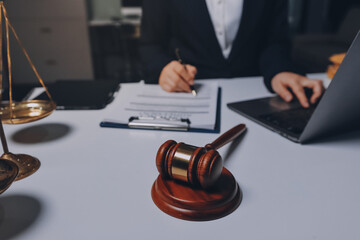 Judge gavel with Justice lawyers having team meeting at law firm background. Concepts of Law and...