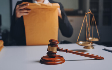 Judge gavel with Justice lawyers having team meeting at law firm background. Concepts of Law and...