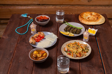Set table for iftar in Ramadan, water, finii, dolma, khinkal and stewed lamb