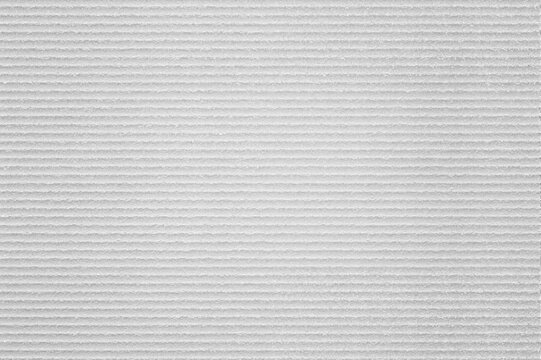 White corrugated cardboard texture, blank paper packaging background with parallel linear ridges.