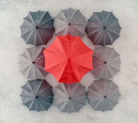 Minimalist 3D Render of One Red Umbrella Among Grey – Top View with High-Contrast Lighting & Monochromatic Simplicity