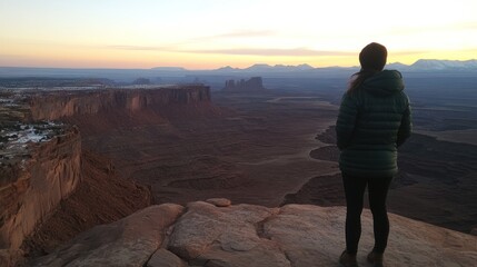 Fototapeta premium Canyonlands Sunrise Solitude: A Woman Contemplates Vast Desert Landscape