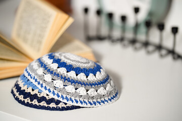 Torah, Jewish kippah, Hanukkah, clock, lie on a white table