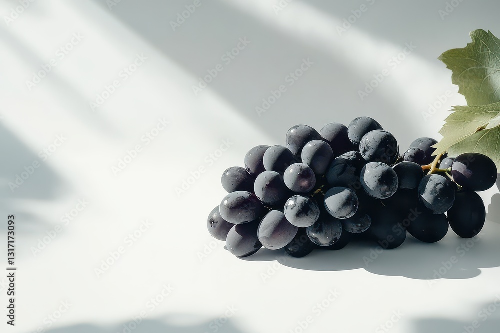 Poster Cluster of ripe black grapes resting on a minimalist surface with soft shadows in the background