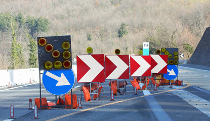 arrows and flashing lights on the highway construction site indicating lane change due to...