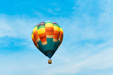 Colorful hot air balloon floating in blue sky