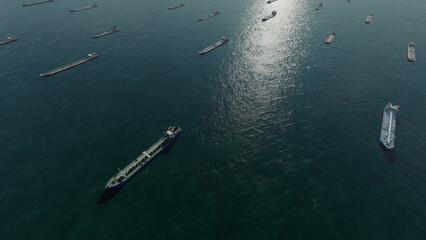Oil tankers in sea. Nautical bulk carrier ships. Crude oil tankers ships, a merchant vessels specially designed for chemical products transportation. Aerial view. Global shipping. Logistic Transport. 