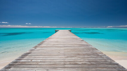 Obraz premium Picturesque wooden pier extending into clear, sparkling waterscape.