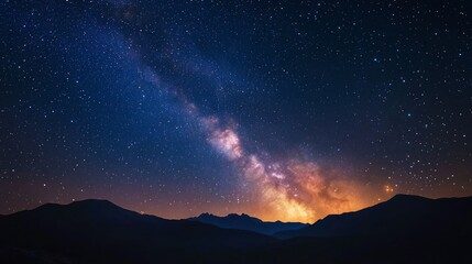 Naklejka premium Majestic Night Sky over Silhouetted Mountains: A Breathtaking Celestial Panorama