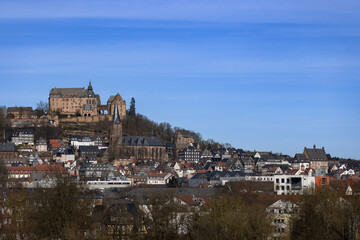 Naklejka premium The Marburg Castle, also Landgrave's castle, above the old town of Marburg with Lutheran Parish Church (mid) and the town hall (r), Hesse, Germany