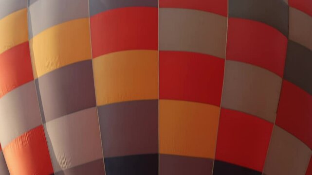 Handheld Orange Yellow Hot Air Balloon on Sky Background. Funny Balloon Festival Activity