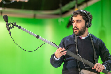 Boom microphone operator testing sound at TV studio. High quality photography © herraez