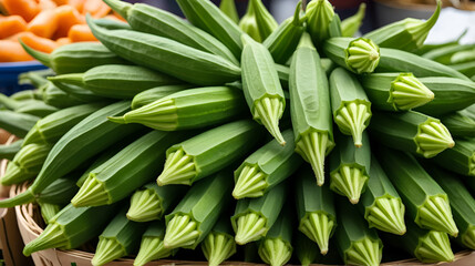 Fototapeta premium Fresh okra stacked high at a vibrant market showcasing organic green vegetables for healthy cooking and local cuisine.