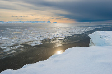 Stunning sunset over the icy waters of Greenland reflecting winter beauty