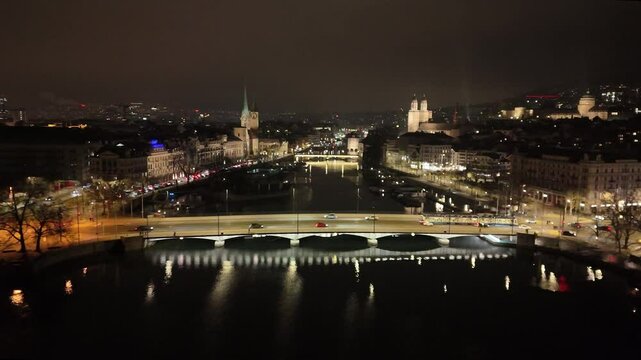 facing zurich night historic center university bridges lake waterfront highlight swiss banking capital backward drone view switzerland backward-facing eth 