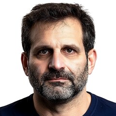 Obraz premium Portrait of a middle-aged man with a thick beard and serious expression against a plain background