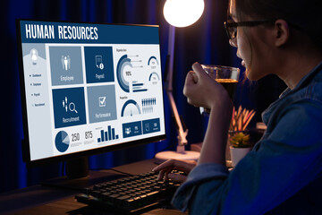 Human resources management software on computer screen helping human resources employee to manage...