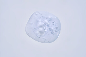 A drop of blue serum with bubbles.