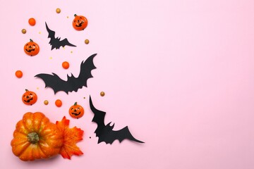 Different Halloween decorations including pumpkins and bats with confetti on color background