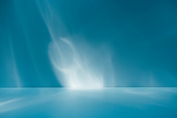 Abstract light blue background for product presentation with sun light reflections and shadows on wall. Winter background.	