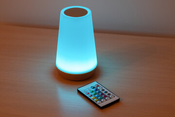 Modern color changing led lamp..Eco rechargeable bedside lamp with remote control for cozy atmosphere at home.