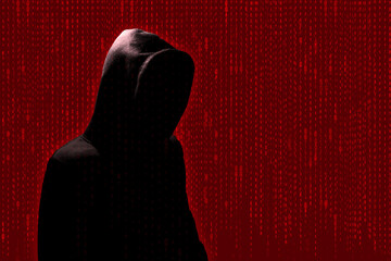 Anonymous Hacker in a hooded sweatshirt with a digital red background