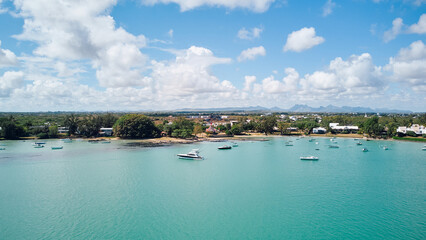 Stunning aerial view of Mauritius' ocean scenery with tall mountains on the horizon