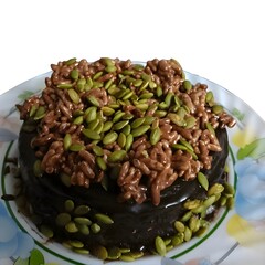 A rich and decadent chocolate cake topped with crunchy rice crisps and nutritious pumpkin seeds. The perfect combination of chocolatey goodness and crispy texture!