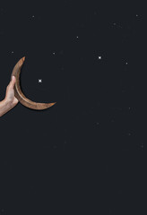 Holding a wooden half moon, Eid Festival concept. Happy Ramadan