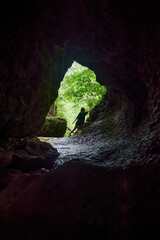 Tourists explore the cave. Speleology and geology. Sports and active leisure