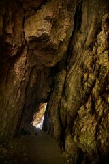 A rock formation in the form of a cave or grotto. Caving and tourism