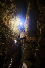 Obraz premium Tourists explore the cave. Speleology and geology. Sports and active leisure