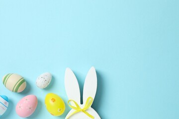 Happy Easter. Colorful eggs with bunny ears on color background, space for text or advertising