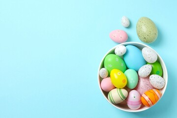 Happy Easter. Colorful eggs in a bowl on color background, space for text or advertising